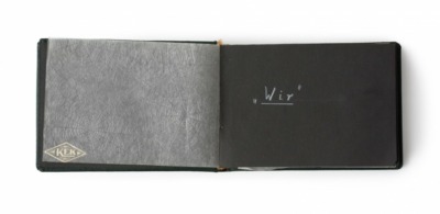 photo album with handwritten inscription that says "wir"