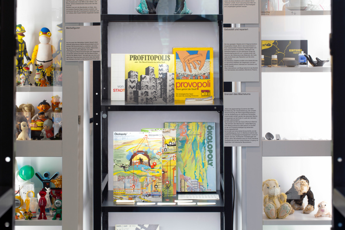 On black shelves, boardgames and magazines on the topic of the Limits of Growth.