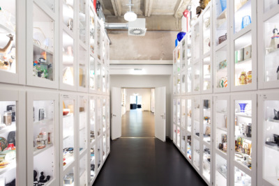 White tall cupboards filled with objects on the left and right.