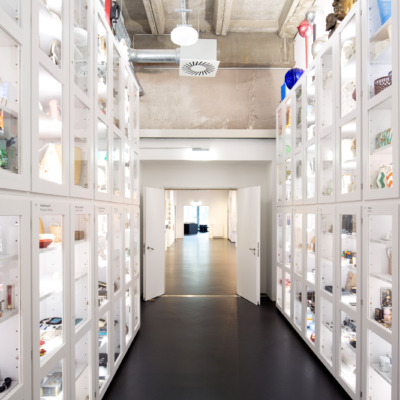 White tall cupboards filled with objects on the left and right.