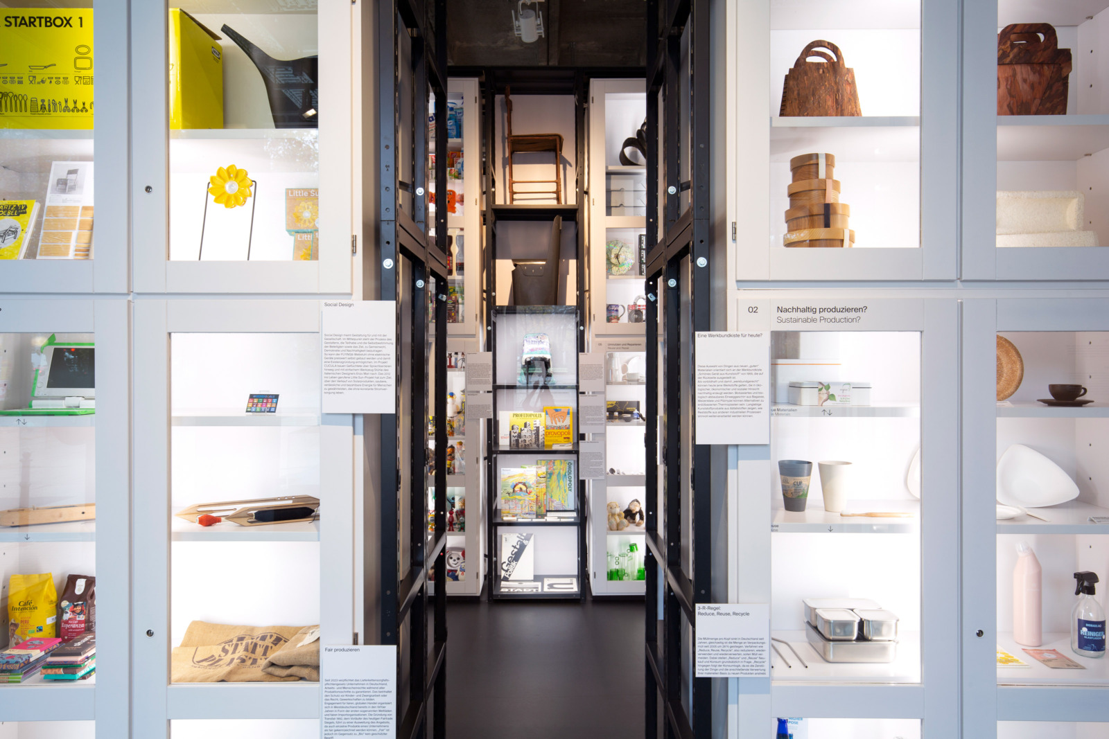 White cupboards on both sides, a black shelf in the background, all filled with exhibits.